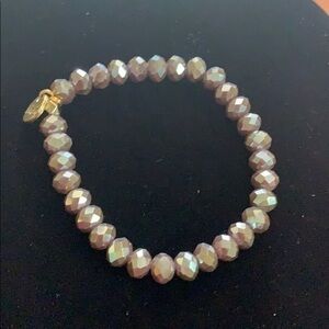 Irridescent beaded bracelet with gold accent